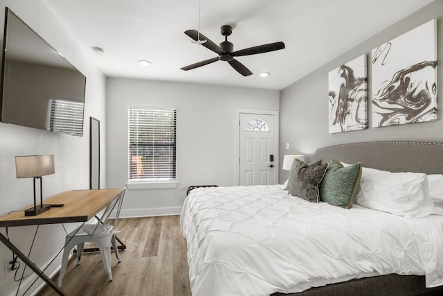 bedroom with ceiling fan and light hardwood / wood-style flooring