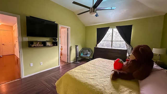 bedroom with ceiling fan, lofted ceiling, and dark wood-type flooring