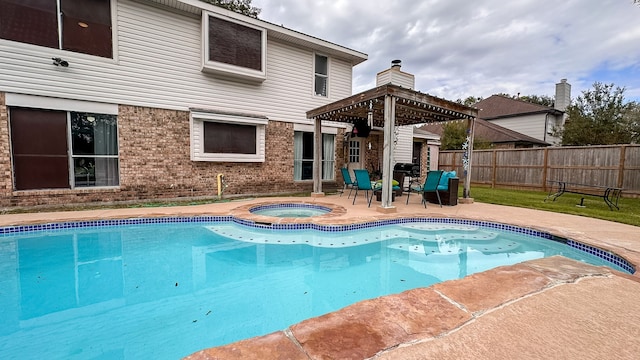 view of swimming pool featuring an in ground hot tub and a patio