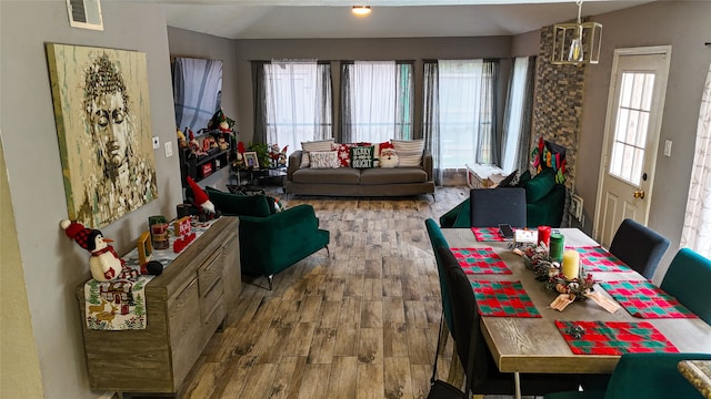 dining space featuring a wealth of natural light, hardwood / wood-style floors, and lofted ceiling