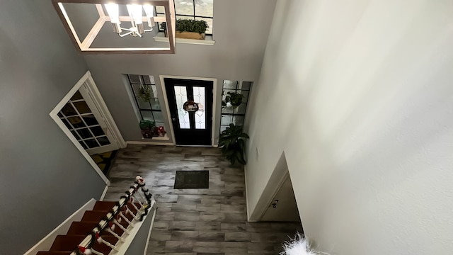 foyer entrance featuring a high ceiling and an inviting chandelier