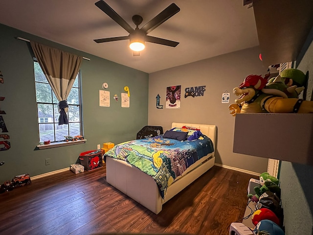 bedroom with ceiling fan and dark hardwood / wood-style flooring