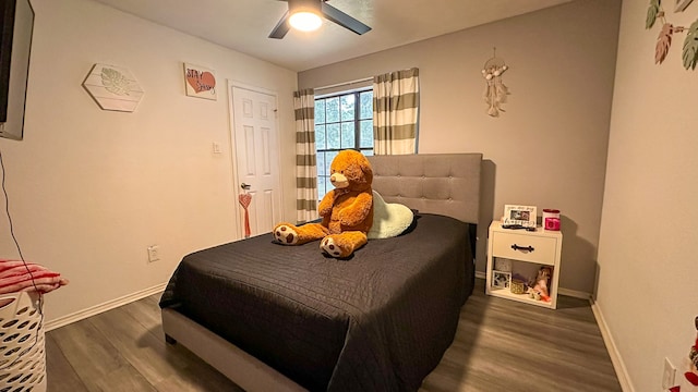 bedroom with ceiling fan and dark hardwood / wood-style flooring