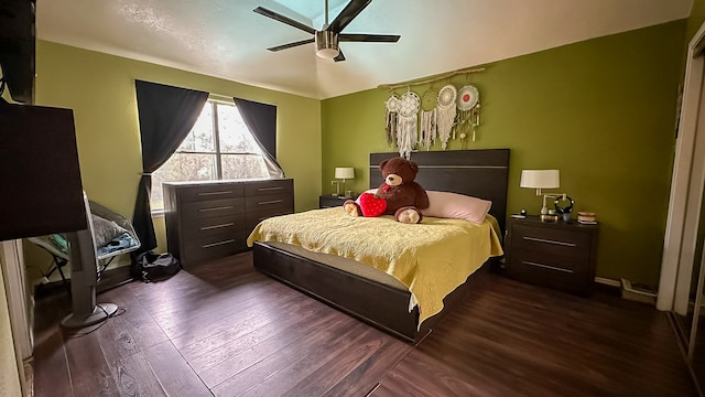 bedroom with ceiling fan and dark hardwood / wood-style flooring