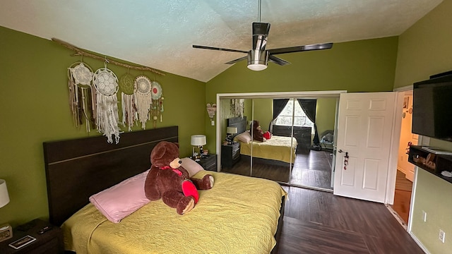 bedroom with dark wood-type flooring, vaulted ceiling, ceiling fan, a textured ceiling, and a closet