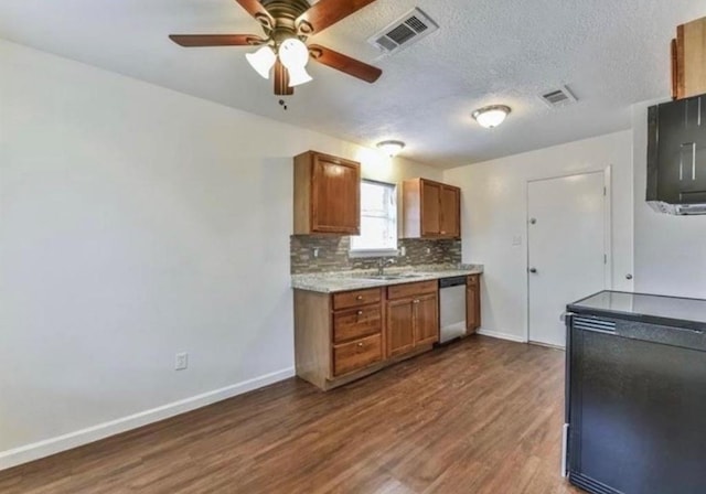 kitchen with ceiling fan, dishwasher, sink, dark wood-type flooring, and backsplash