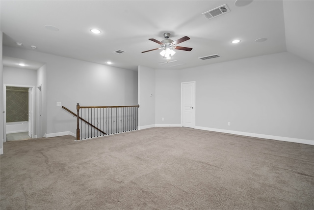 empty room with carpet flooring, ceiling fan, and vaulted ceiling