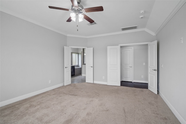 unfurnished bedroom with carpet flooring, crown molding, ceiling fan, and vaulted ceiling