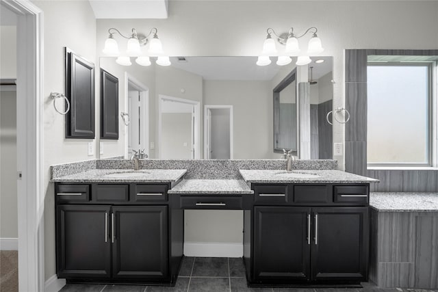 bathroom with tile patterned flooring, vanity, and a healthy amount of sunlight