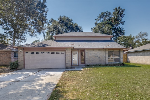 view of front of property with a garage and a front lawn