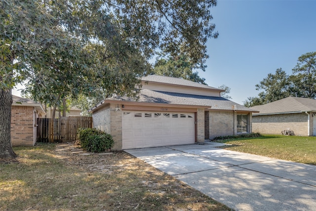 view of property featuring a front lawn and a garage