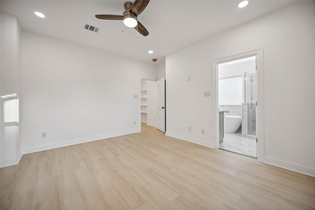 unfurnished bedroom with light wood-style floors, baseboards, connected bathroom, and recessed lighting