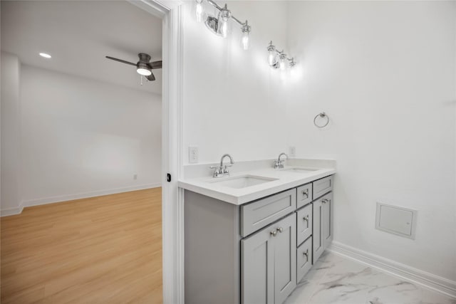 bathroom with hardwood / wood-style floors, vanity, and ceiling fan