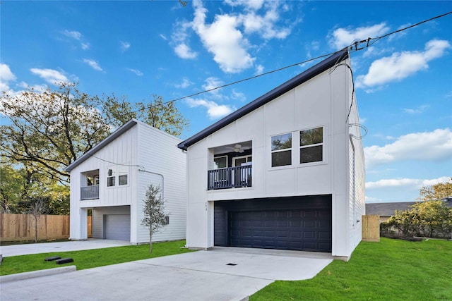 view of front of property featuring a balcony, a front yard, and a garage