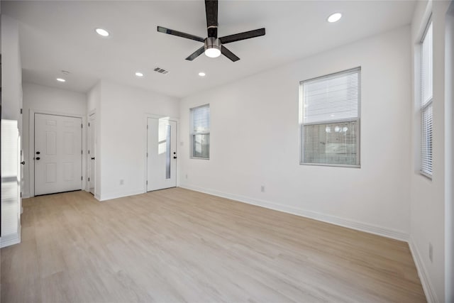 spare room featuring ceiling fan and light wood-type flooring