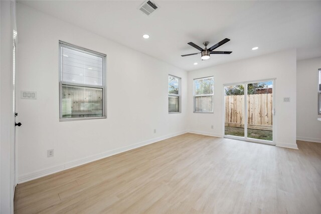 spare room with ceiling fan and light wood-type flooring