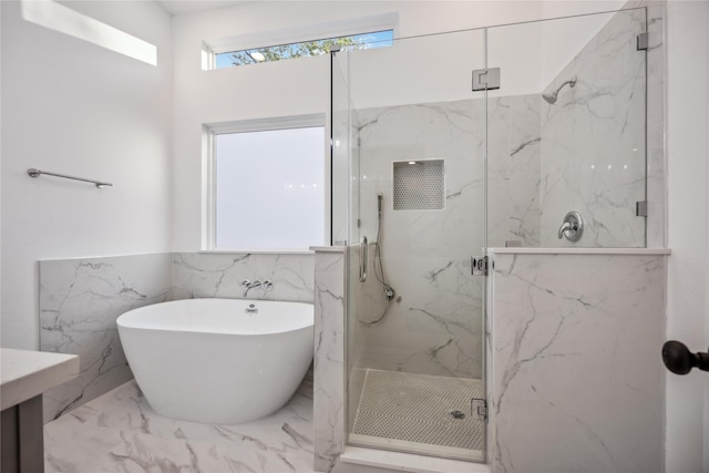 bathroom with separate shower and tub and tile walls