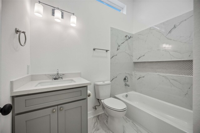 bathroom with a tub to relax in, vanity, and toilet