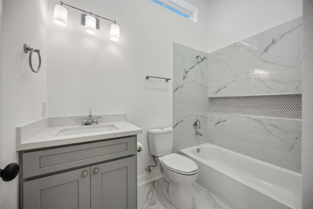 bathroom featuring toilet, marble finish floor, shower / bathing tub combination, and vanity