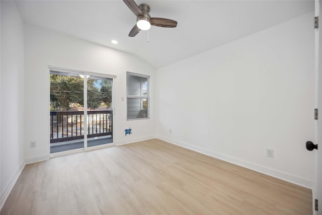 empty room featuring baseboards, ceiling fan, vaulted ceiling, and light wood-style floors