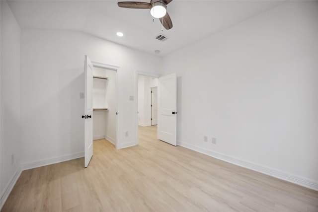 unfurnished bedroom with a ceiling fan, baseboards, visible vents, a spacious closet, and light wood-style floors