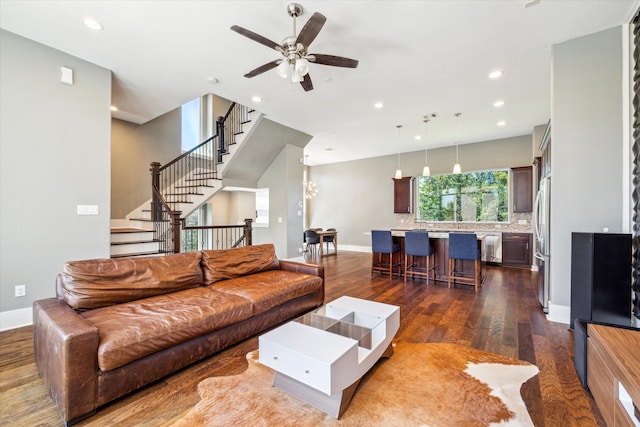 living room with ceiling fan and dark hardwood / wood-style floors