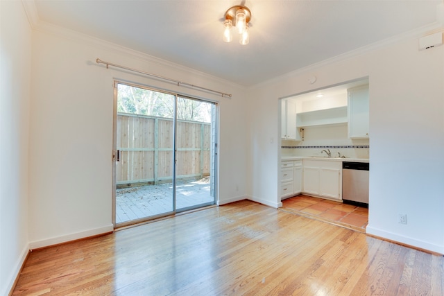 interior space featuring light wood-type flooring, tasteful backsplash, stainless steel dishwasher, crown molding, and white cabinets