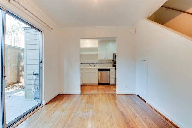 interior space with light hardwood / wood-style floors, sink, and crown molding