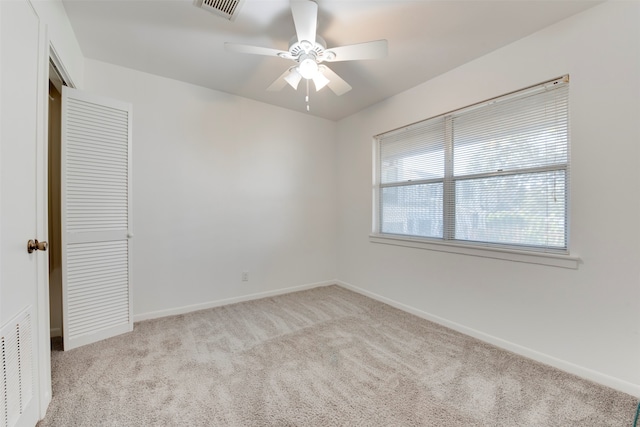 empty room with light carpet and ceiling fan