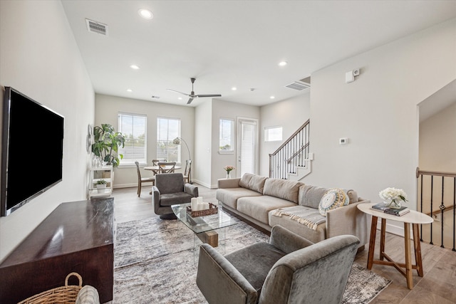 living room with ceiling fan and light hardwood / wood-style floors