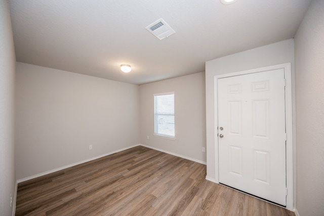 spare room with wood-type flooring