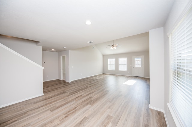 unfurnished living room featuring ceiling fan, lofted ceiling, and light hardwood / wood-style flooring