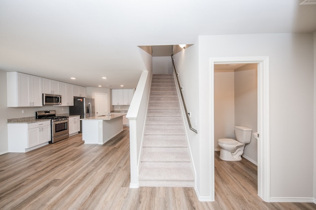 staircase featuring hardwood / wood-style floors