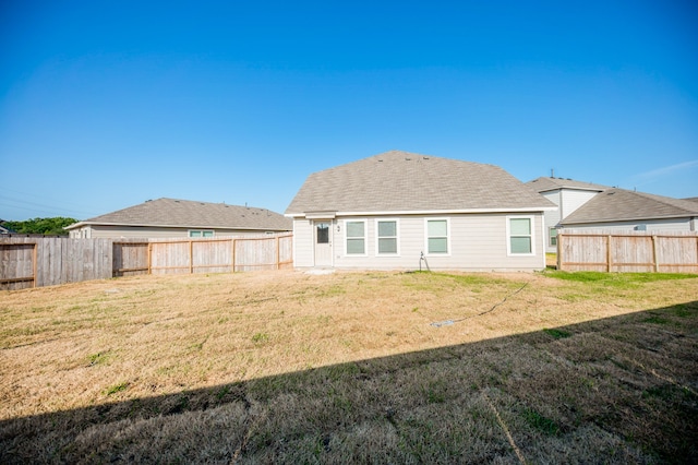 back of house featuring a yard