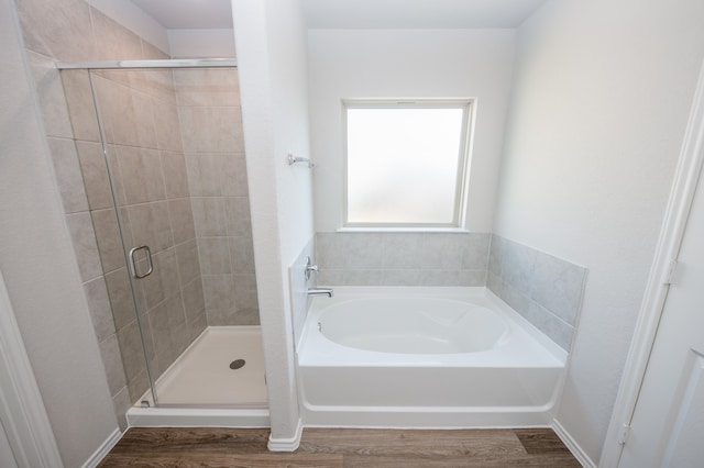 bathroom featuring hardwood / wood-style floors and independent shower and bath