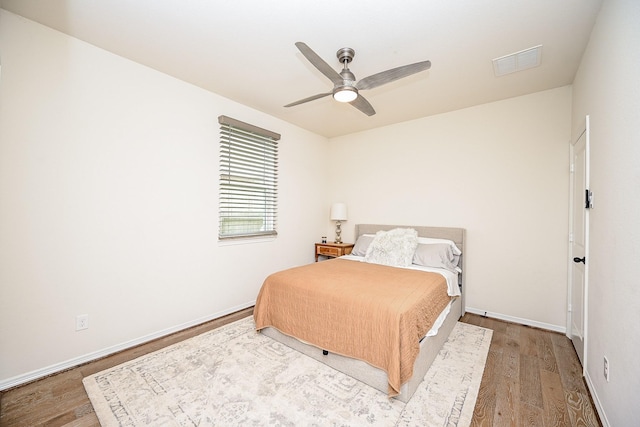 bedroom with hardwood / wood-style floors and ceiling fan