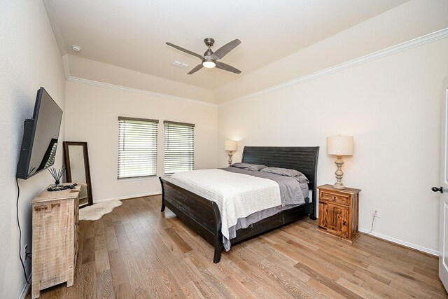 bedroom with ceiling fan, ornamental molding, and hardwood / wood-style flooring