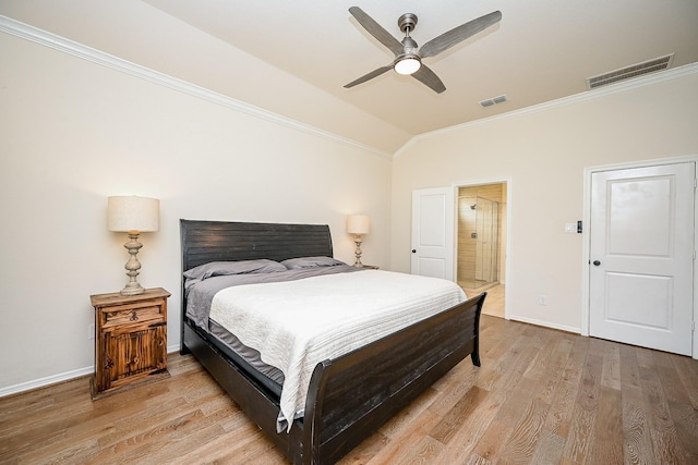 bedroom with ceiling fan, ornamental molding, vaulted ceiling, and light wood-type flooring