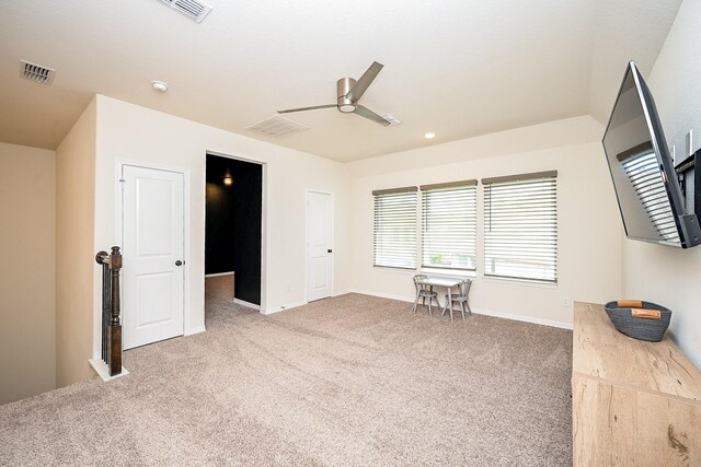 interior space with ceiling fan and carpet floors