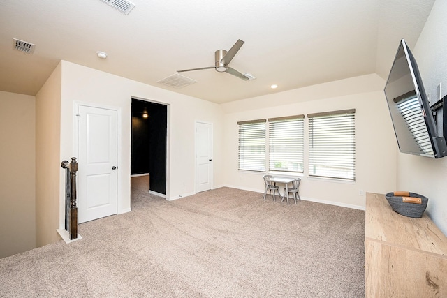 interior space featuring carpet floors and ceiling fan