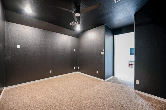 unfurnished room with ceiling fan, carpet, and a textured ceiling