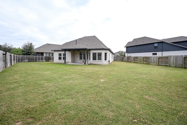 back of house with a patio and a yard