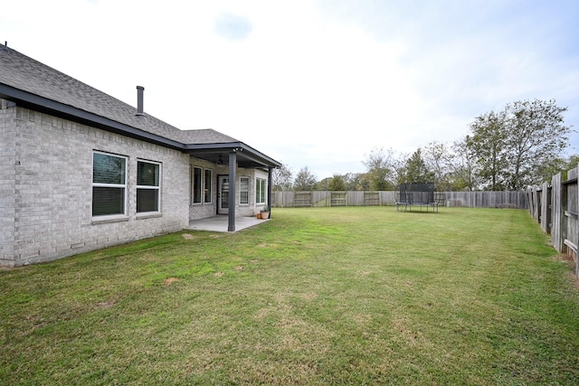 view of yard featuring a trampoline and a patio area