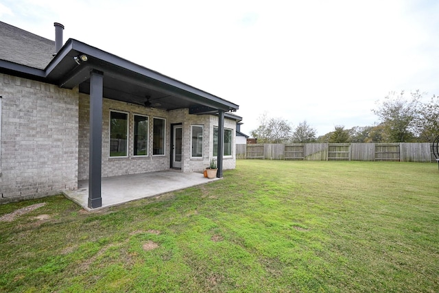 view of yard featuring ceiling fan and a patio