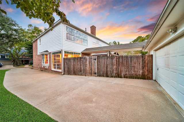 property exterior at dusk featuring a garage