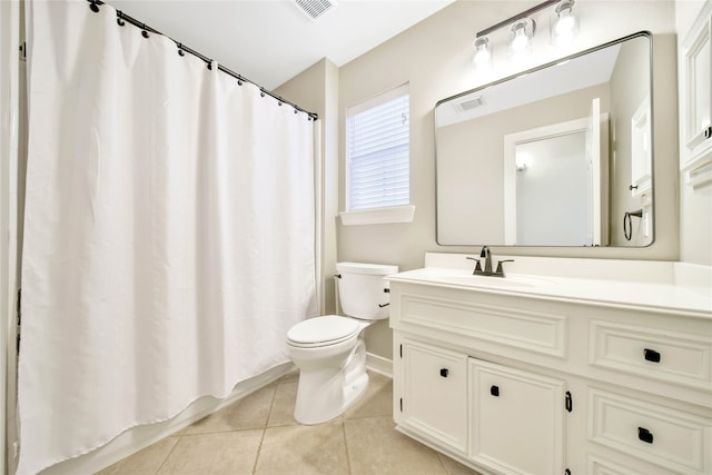 bathroom featuring tile patterned flooring, vanity, and toilet