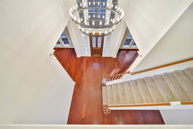 foyer featuring a chandelier, a high ceiling, and hardwood / wood-style flooring