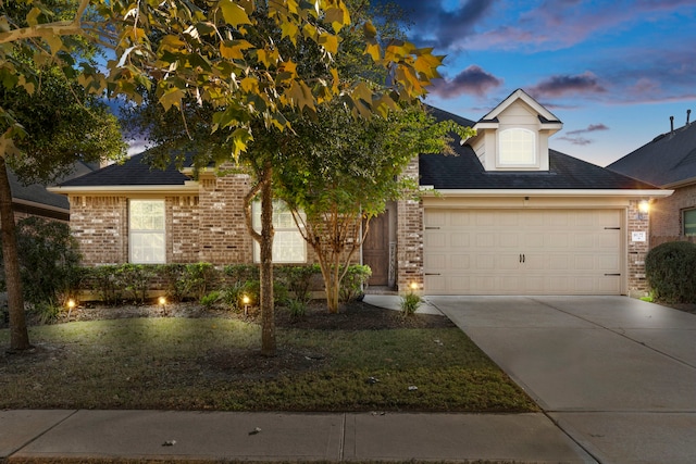 view of front facade with a lawn and a garage