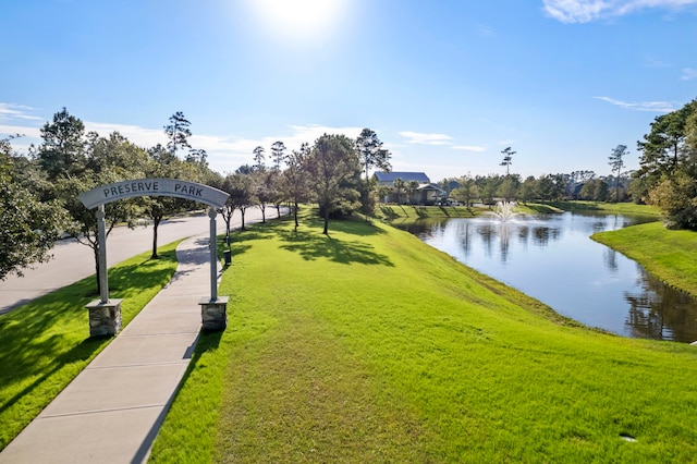 view of home's community featuring a yard and a water view