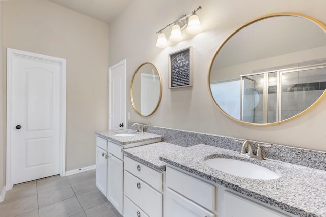 bathroom with tile patterned flooring, an enclosed shower, and vanity